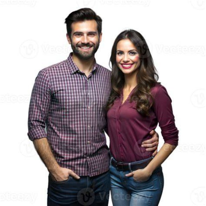 a man and woman standing next to each other on a red carpet